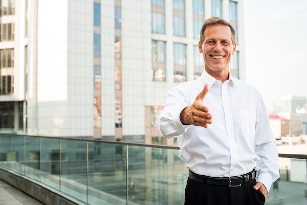 Free photo businessman with hand reaching out