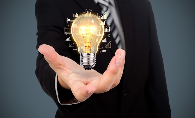 Free photo businessman with a light bulb in his hand