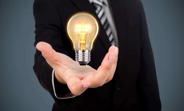 Free Photo businessman with a light bulb in his hand