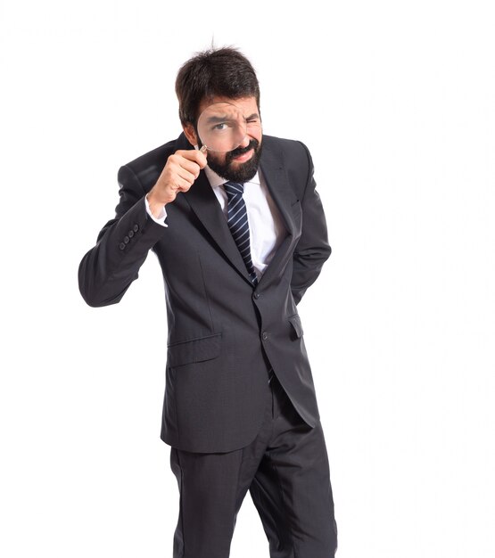 Businessman with magnifying glass over white background