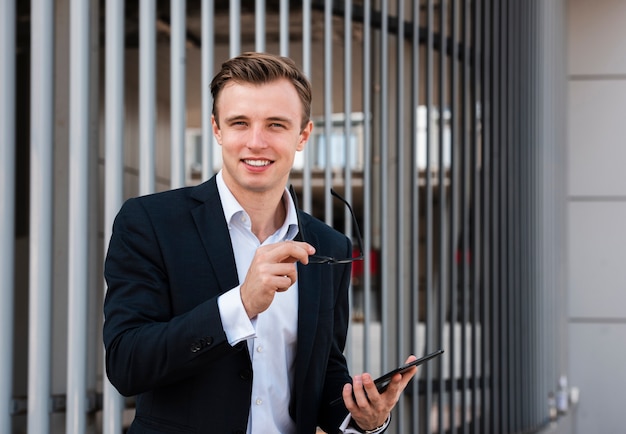 Businessman with tablet looking at camera