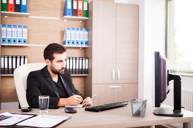 Free photo businessman working in his office. businessperson in professional environment