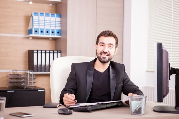 Businessman working at his office. Businessperson in professional environment