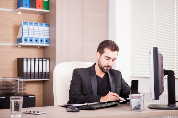 Businessman working at his office. Businessperson in professional environment