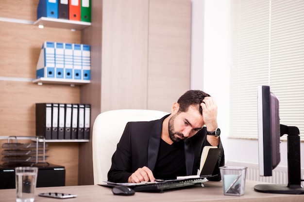 Businessman working in his office. Businessperson in professional environment