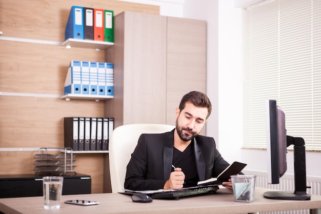 Businessman working in his office. Businessperson in professional environment