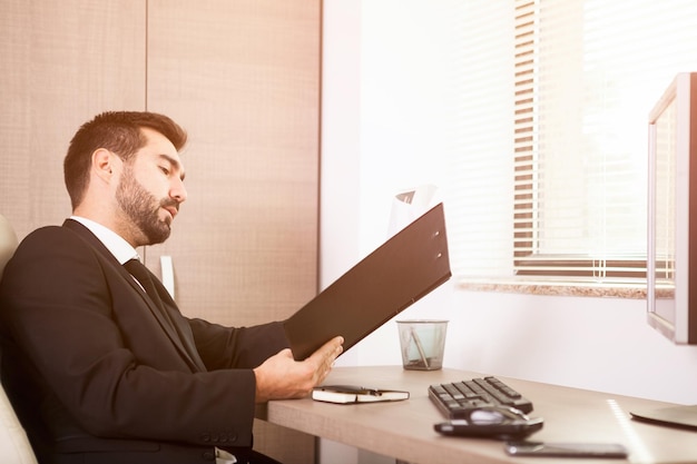 Businessman working in his office. Businessperson in professional environment