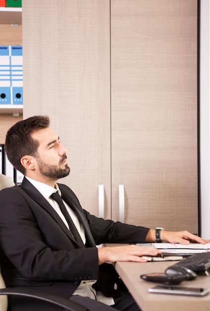 Free photo businessman working in his office. businessperson in professional environment