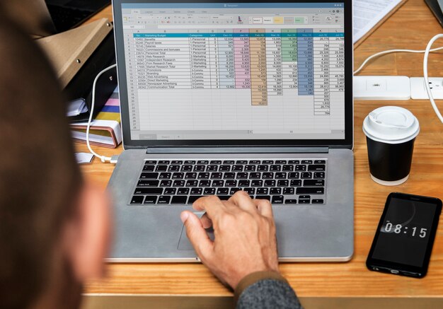 Businessman working a on laptop in a meeting