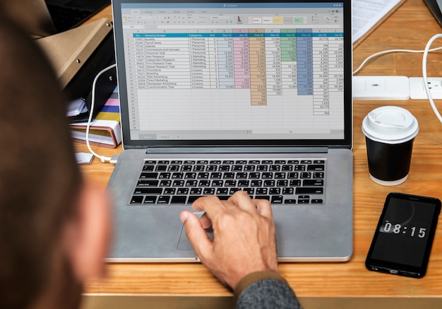 Businessman working a on laptop in a meeting