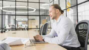 Free photo businessman working with laptop in office