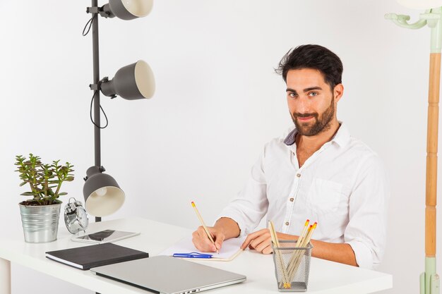 Businessman writing and posing