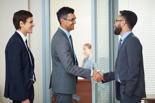 Free photo businessmen closing a deal with a handshake