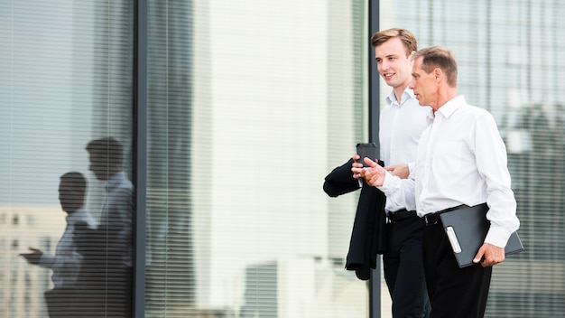 Businessmen discussing while walking