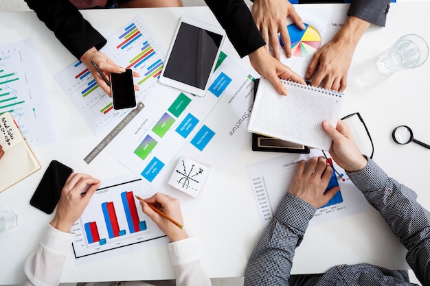  businessmen hands on white table with documents and drafts