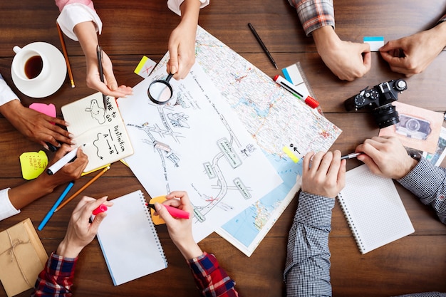 Free photo businessmen hands on wooden table with documents and drafts