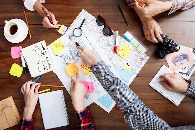 Free photo businessmen hands on wooden table with documents and drafts