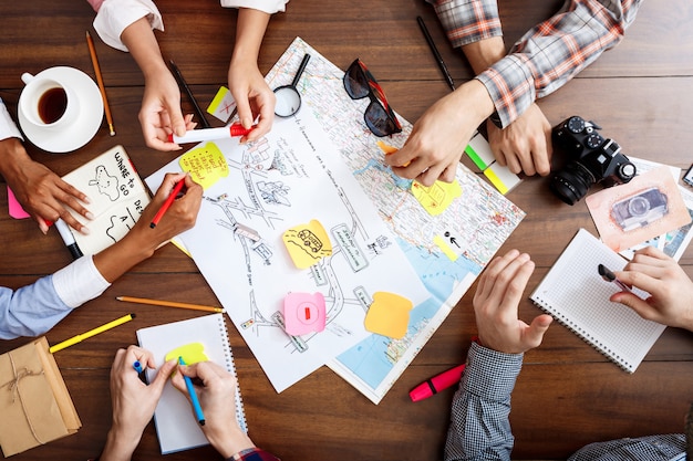 Free Photo  businessmen hands on wooden table with documents and drafts