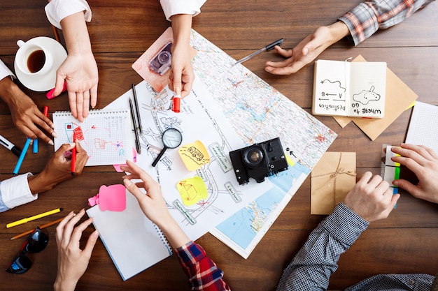 Free Photo  businessmen hands on wooden table with documents and drafts