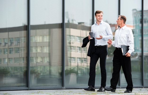 Businessmen having a conversation while walking