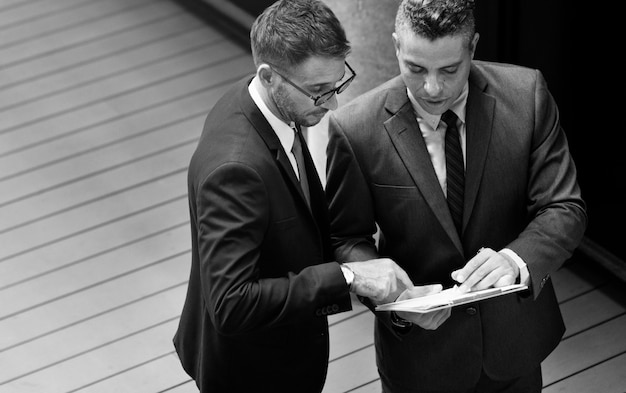 Free Photo businessmen talking together grayscale