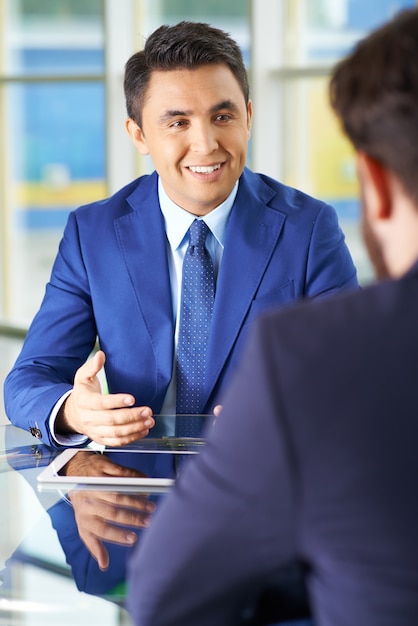 Businessmen using a touchpad in a meeting