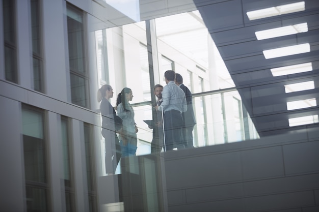 Free photo businesspeople interacting inside office building