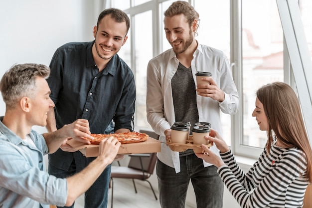 Businesspeople on lunch break eating pizza