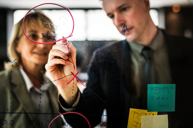 Free Photo businesspeople planning on a glass wall