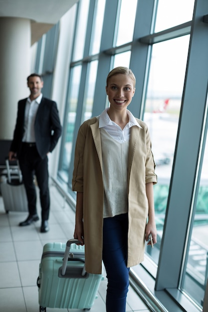 Businesspeople with luggage at airport