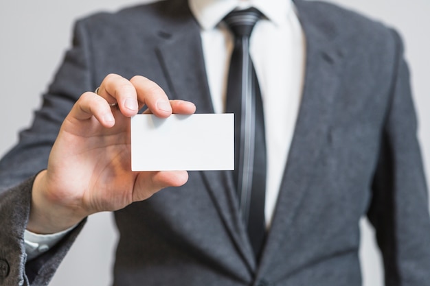 Businessperson's hand showing blank visiting card