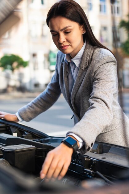 Businesswoman checking the car's motor