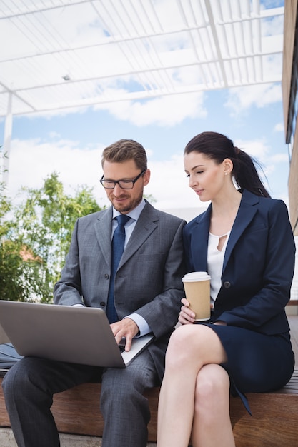 Businesswoman and colleague using laptop