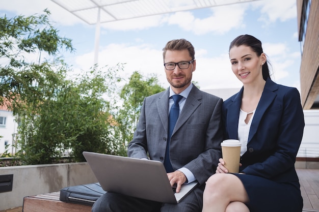 Businesswoman and colleague using laptop