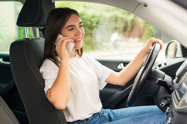 Businesswoman driving the car and angrily talking on the phone