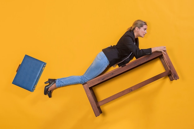 Businesswoman floating on a bench