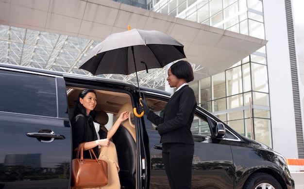 Businesswoman getting in a taxi cab