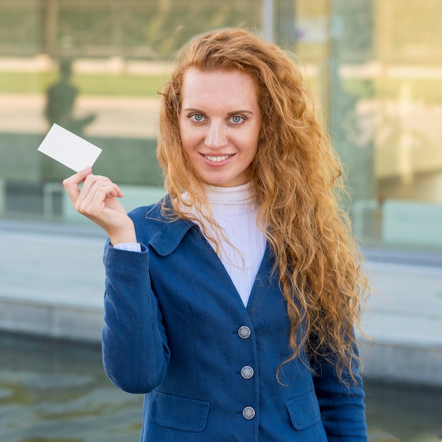 Free Photo businesswoman holding a business card medium shot