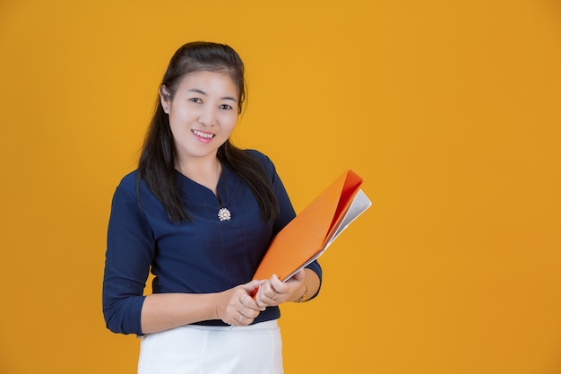 businesswoman holding file in orange