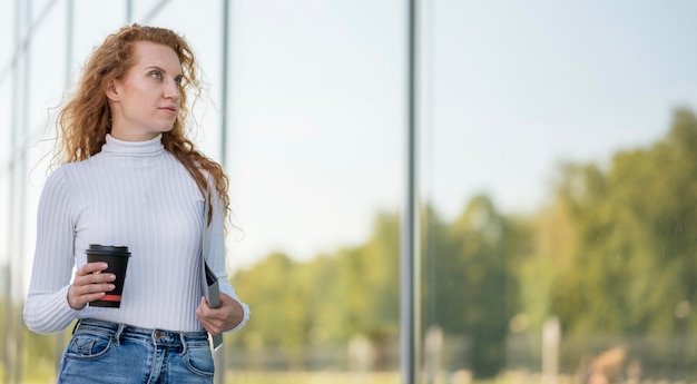 Free photo businesswoman holding her morning coffee medium shot