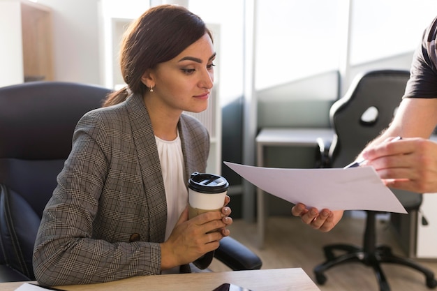 Businesswoman looking at papers in the office