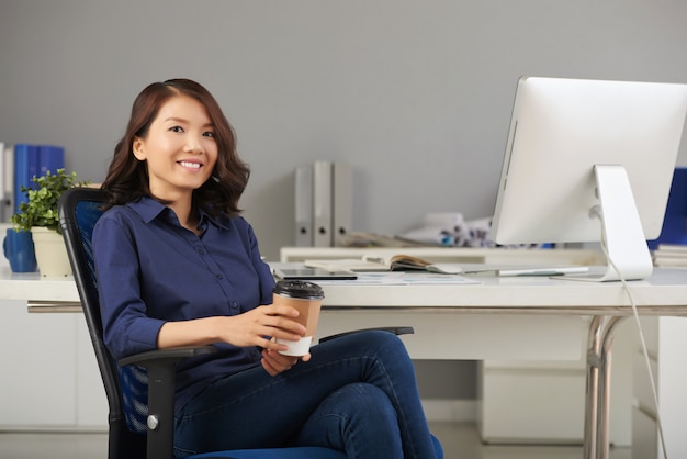 Businesswoman posing in office chair