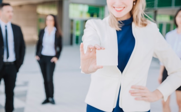 Free photo businesswoman showing business card