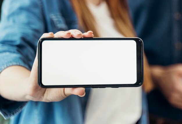 Businesswoman showing an empty screen phone