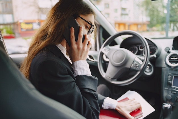 Businesswoman sitting inside a car