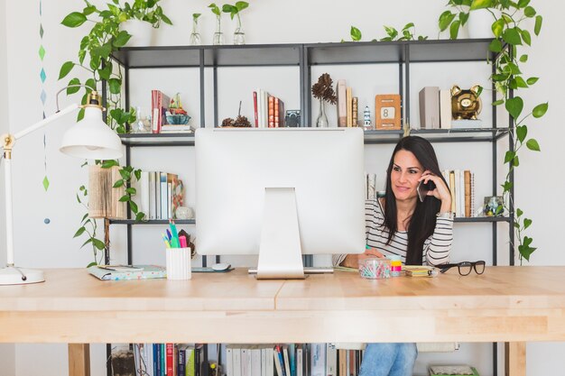 Businesswoman smiling while talking on the phone