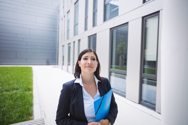 Businesswoman standing outside office building