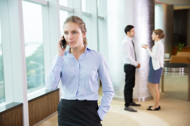 Free photo businesswoman talking on phone in office 4