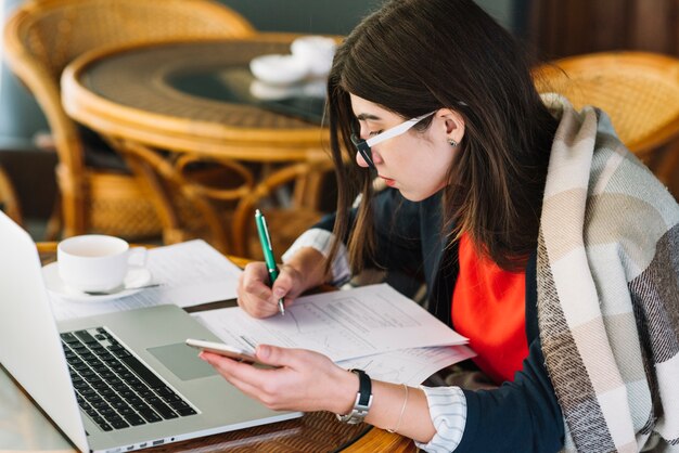 Businesswoman using laptop in coffee shop