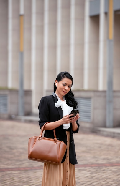 Businesswoman waiting outdoors for her taxi